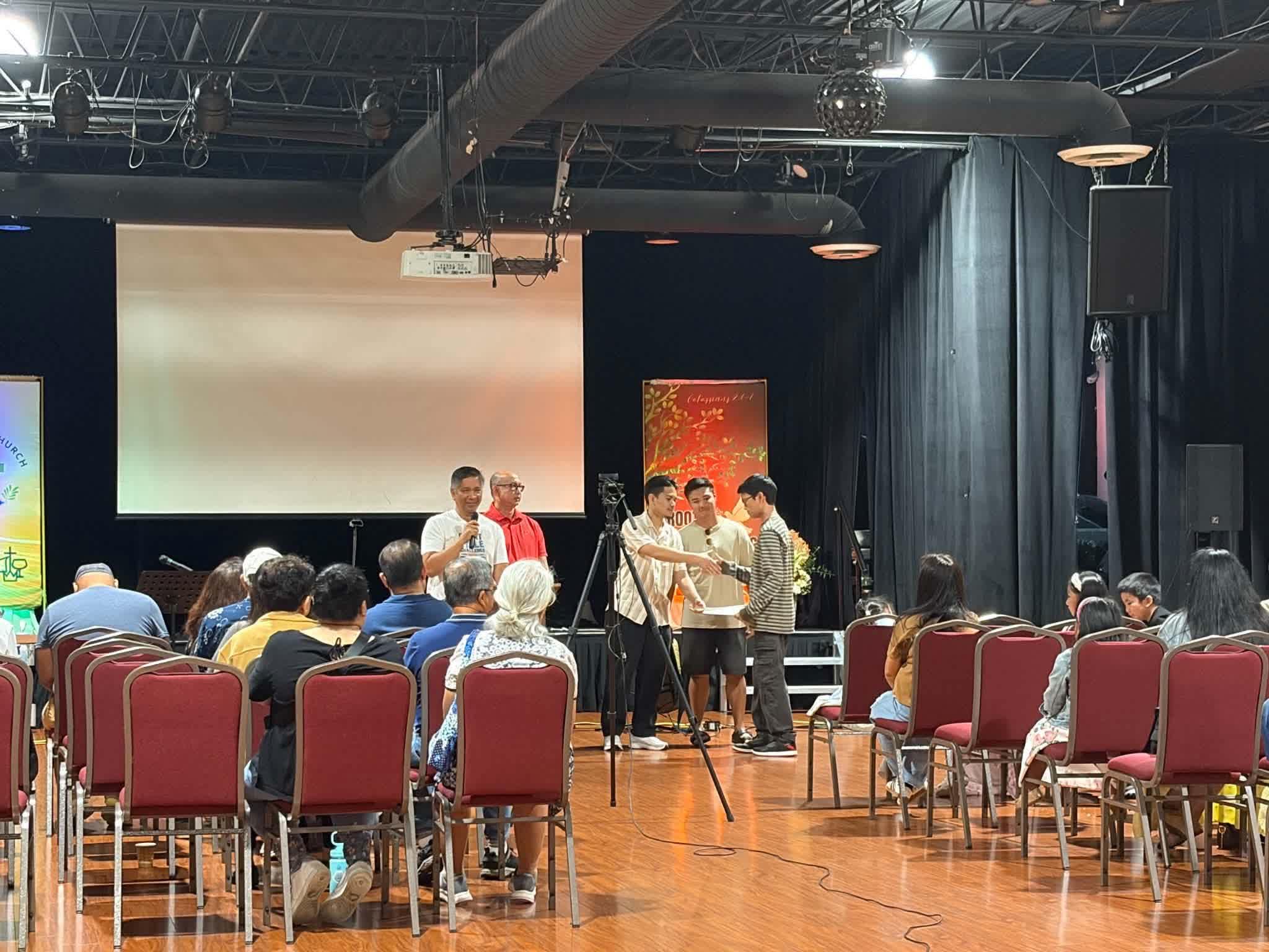 FCC members praying together during a Sunday service