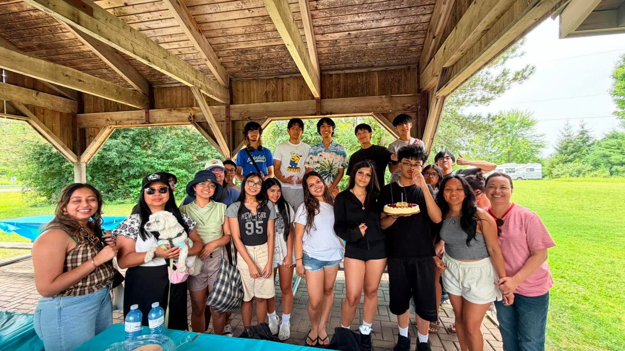 FCC youth gathered under a pavilion at a summer picnic